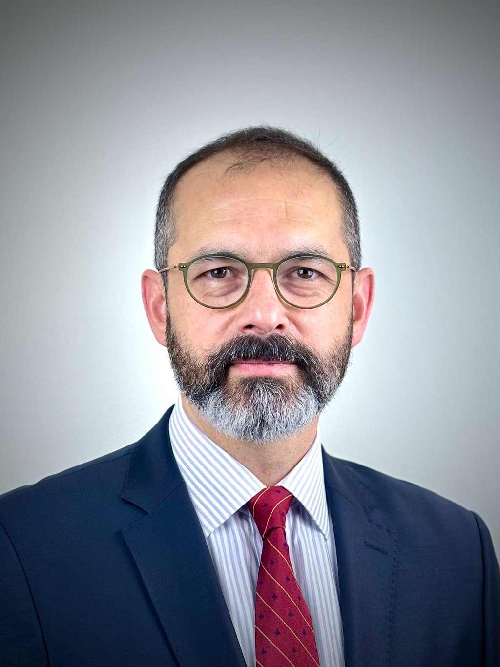 a man with a beard and glasses on a white background