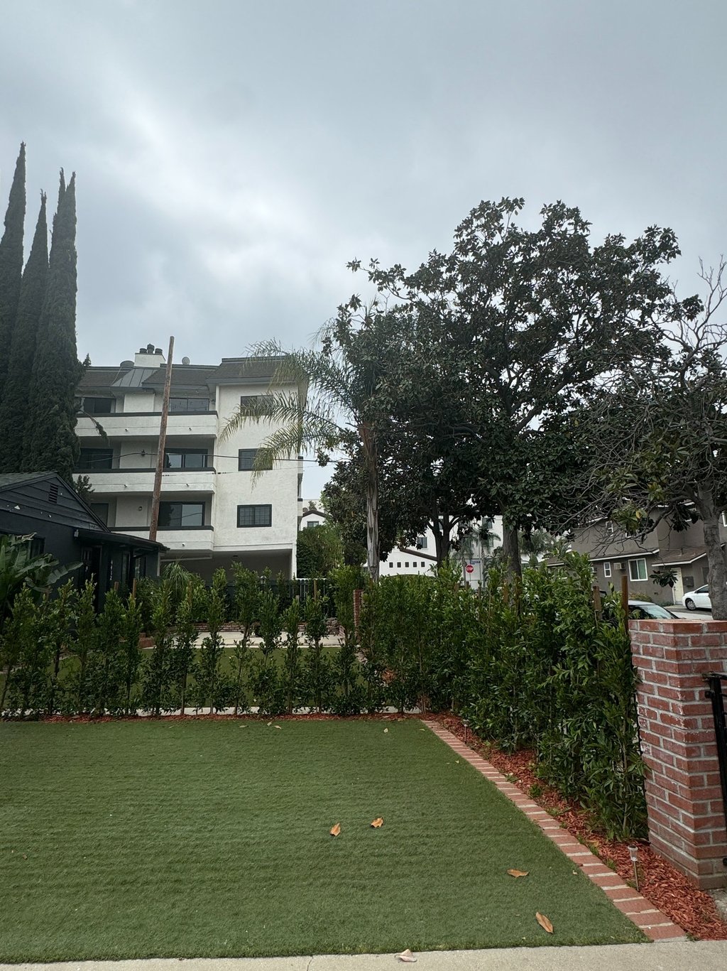 a house with a lawn and a fenced in area