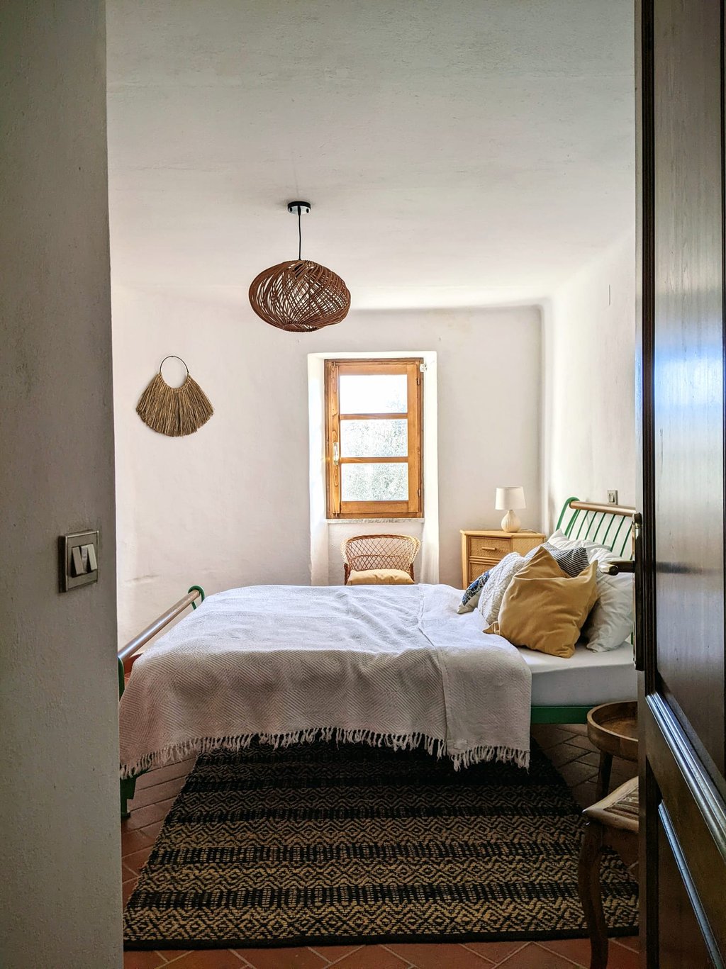 a bedroom with a bed and a chair