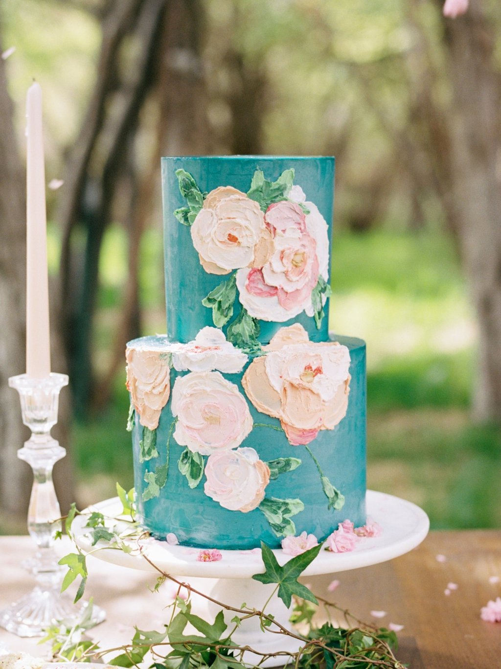 A fun blue wedding cake with buttercream flowers for luxurious Montana wedding
