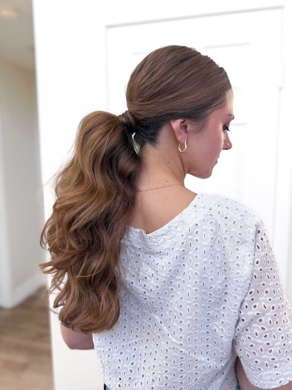 Central Valley vineyard bride with effortless, soft-textured bridal ponytail in golden sunset light
