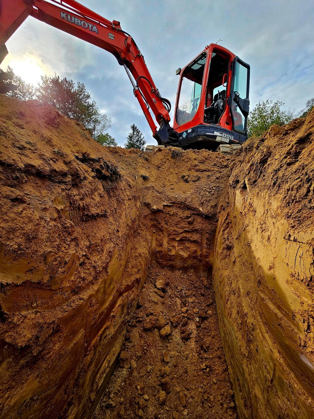 a construction worker is working on a trench
