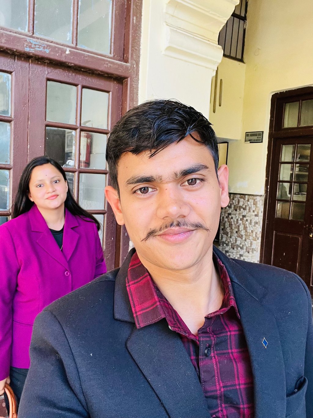 a man and woman standing in front of a door