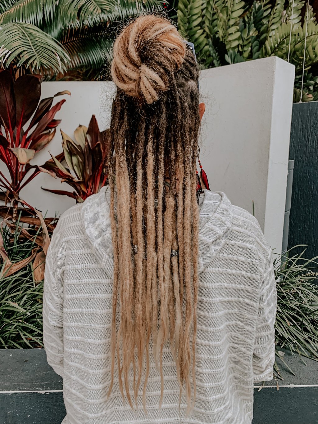 a woman with long hair and dreadlocks on her head
