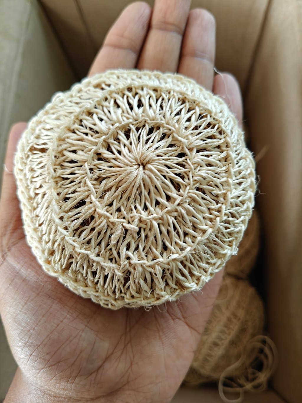 Hand-held eco-friendly sisal fiber scrubbing sponge for natural dishwashing and plastic-free cleaning.