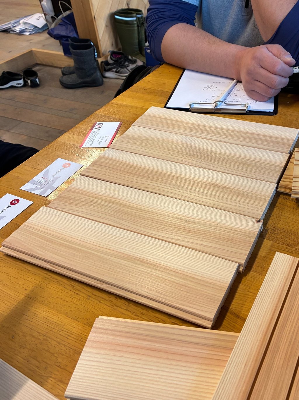 Natural sugi wood panelling samples displayed on a table for home renovation project planning.