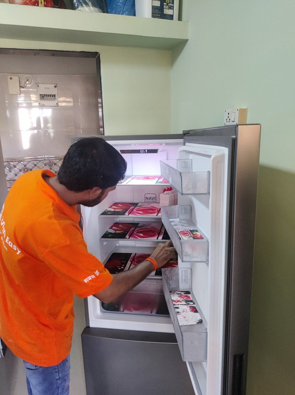 Appliance repair technician fixing a refrigerator in Jodhpur