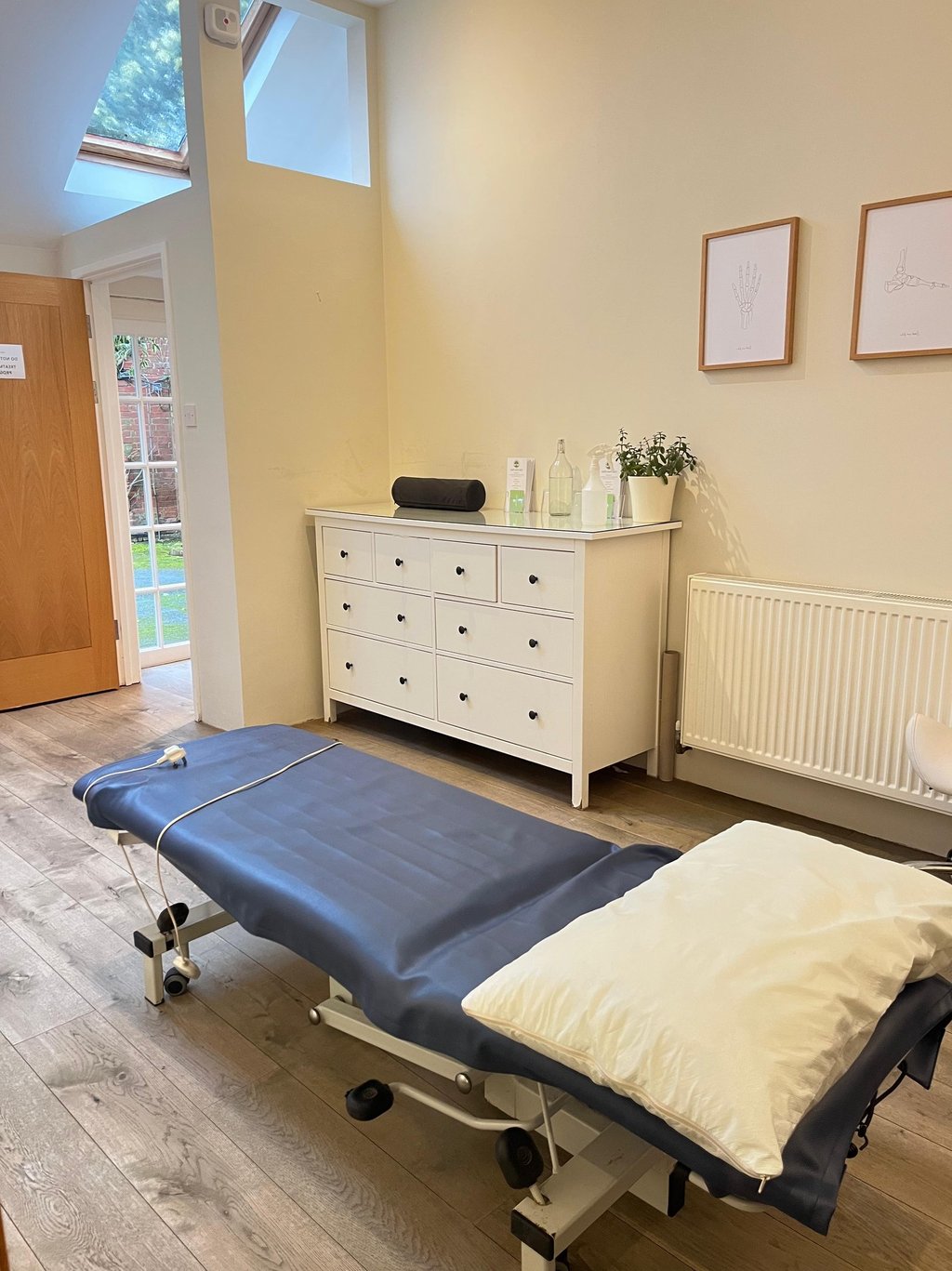 clinic room with wooden floors and patient couch