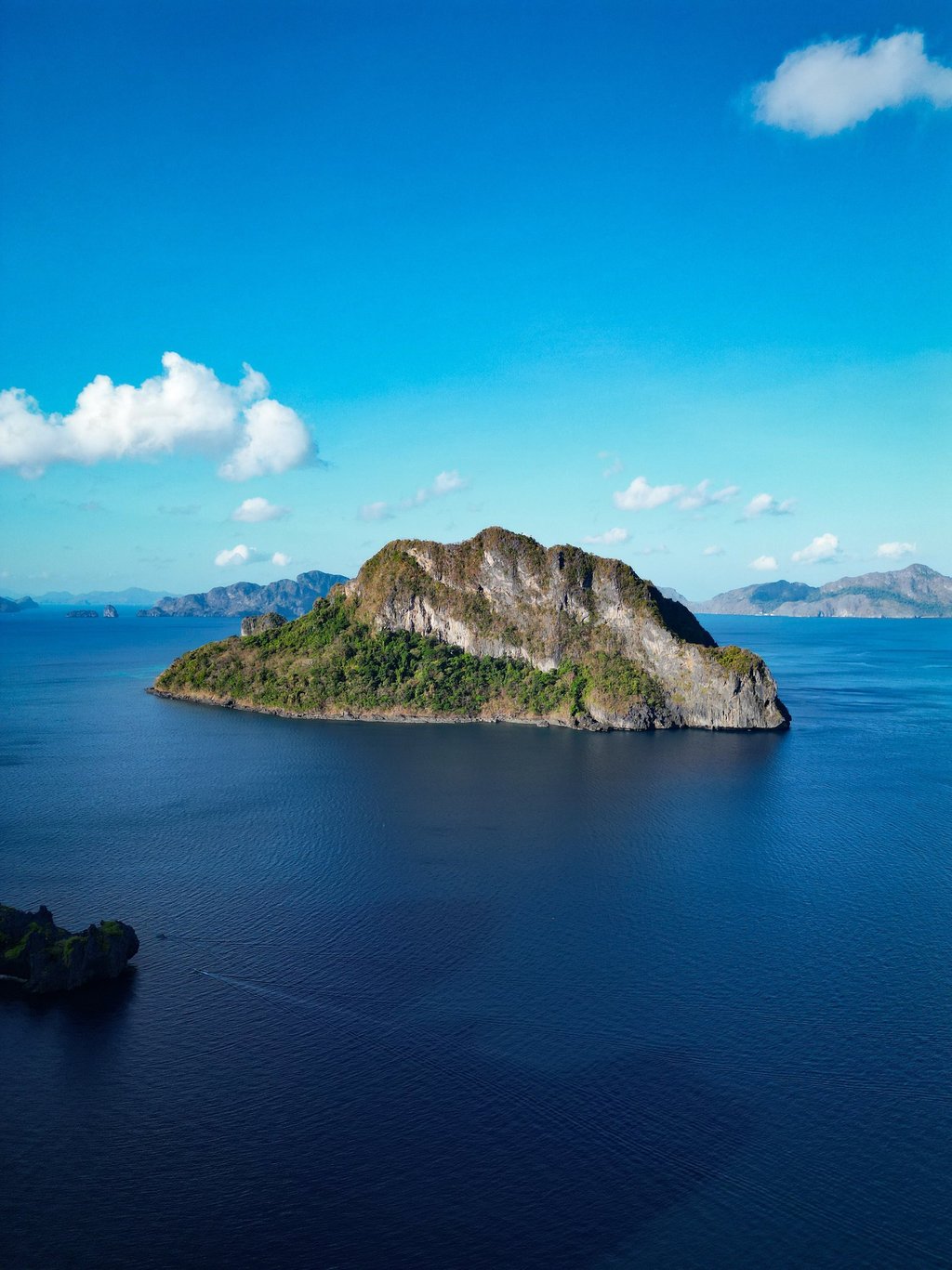 a small island with a small island in the middle of the ocean