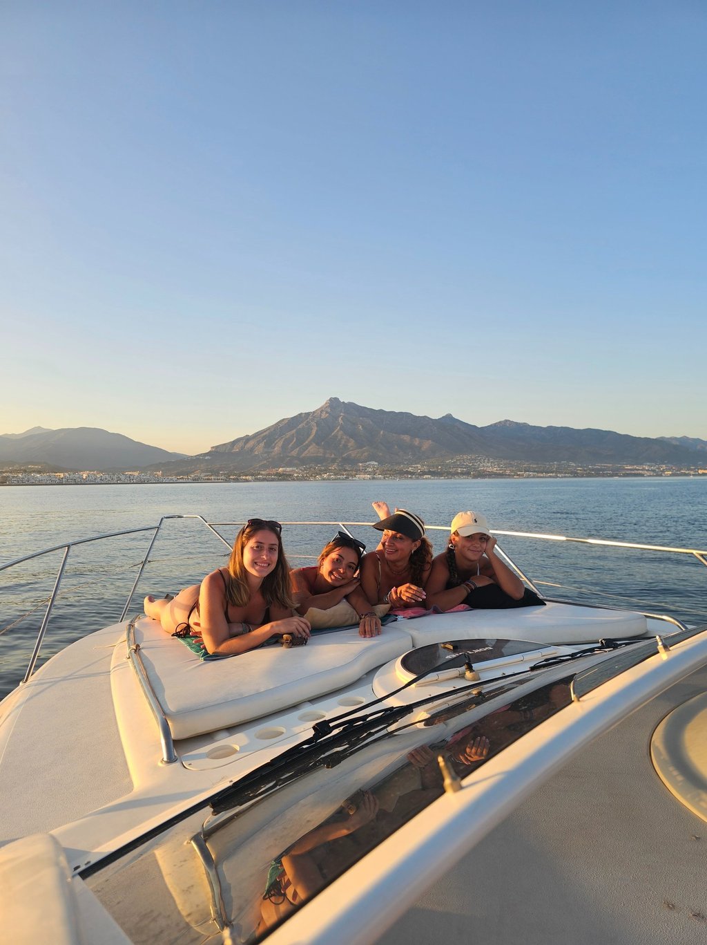 three girls on a boat in the ocean