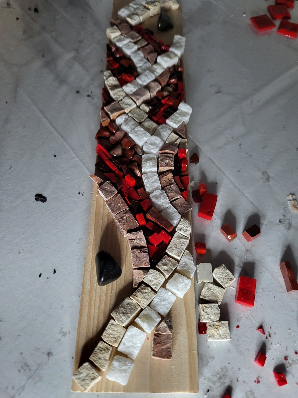a wooden cutting board with a mosaic tile pattern