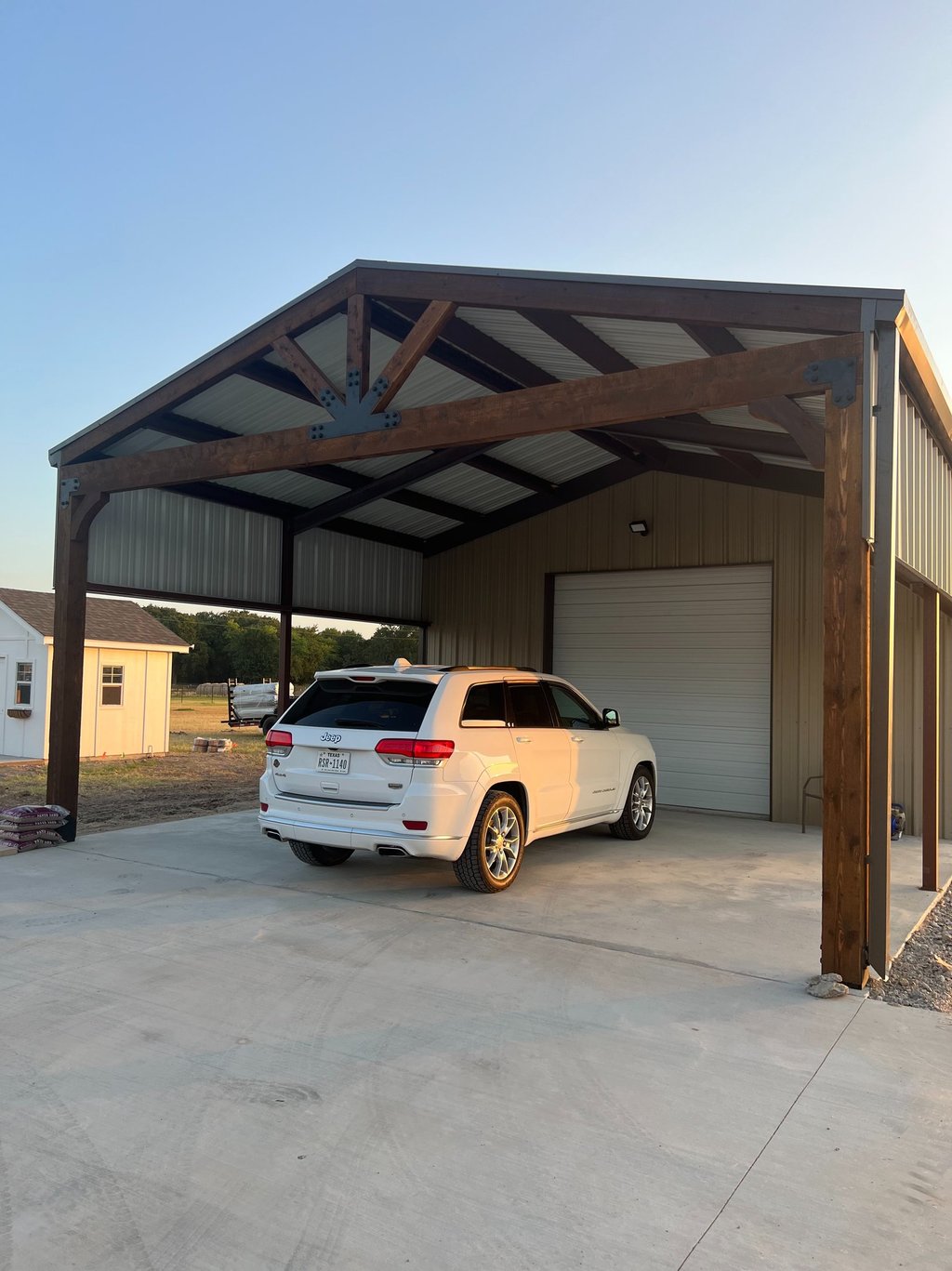 Covered carport with wooden beams.