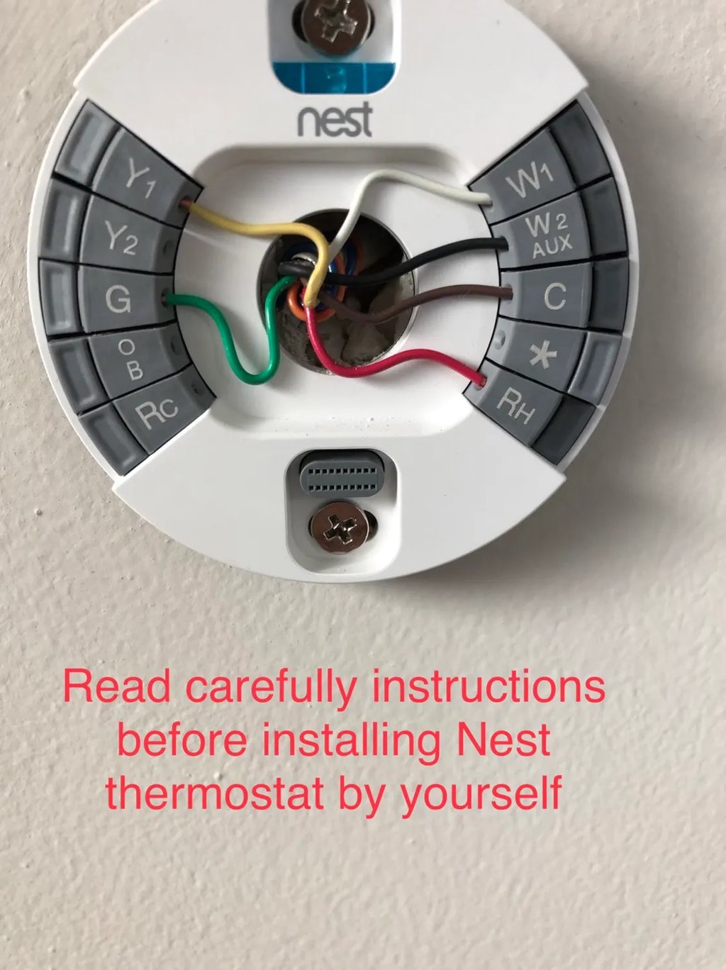 Nest Thermostat Installation photo with message in red to read instructions before installing thermostat by yourself