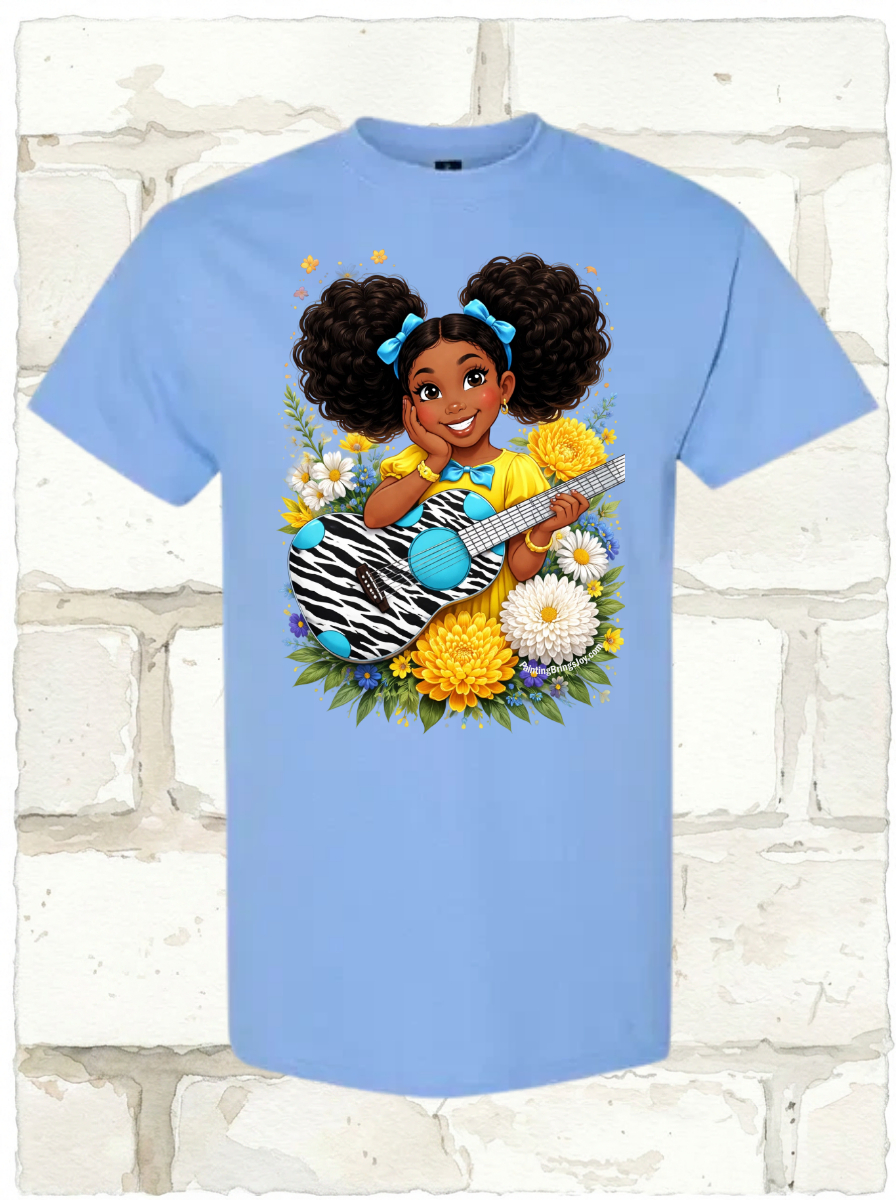 Light blue t-shirt featuring a cartoon girl with puff pigtails holding a zebra print guitar among flowers.