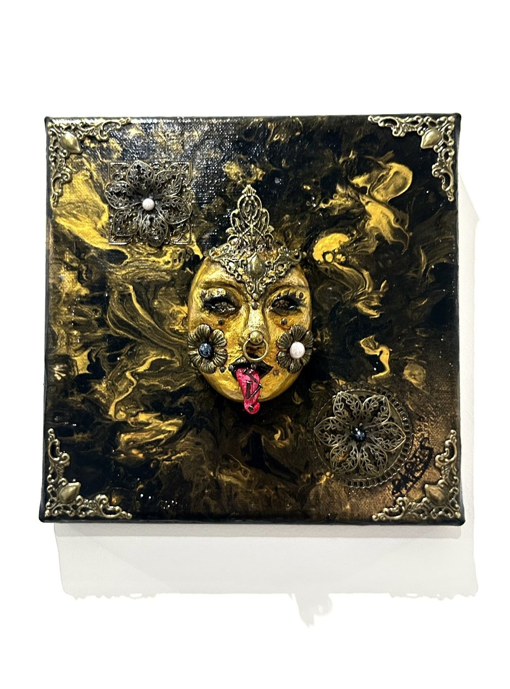 a painting of a woman's face with a gold face
