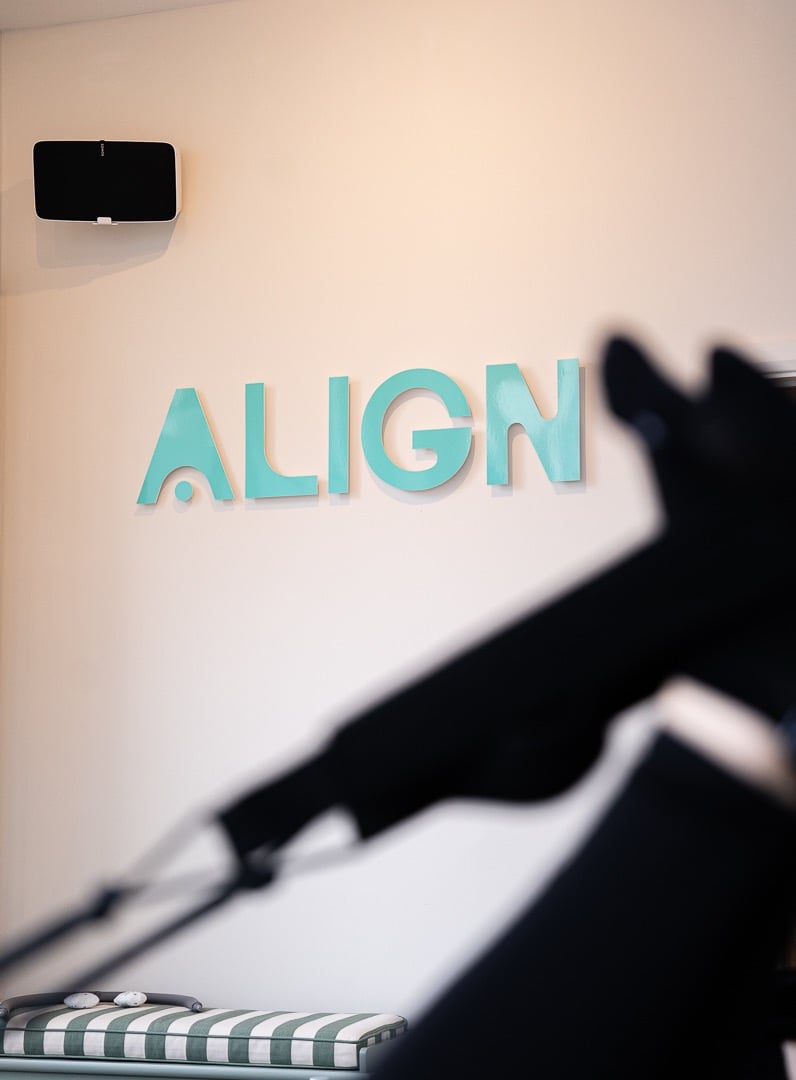 sign align in turquoise on the wall
