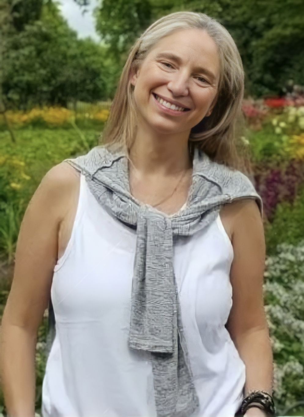 a woman in a white tank top and a gray scarf cecilia aylion