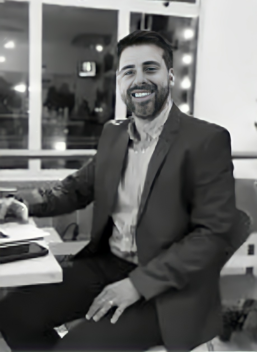 a man in a suit and tie smiling at the camera alejandro lange