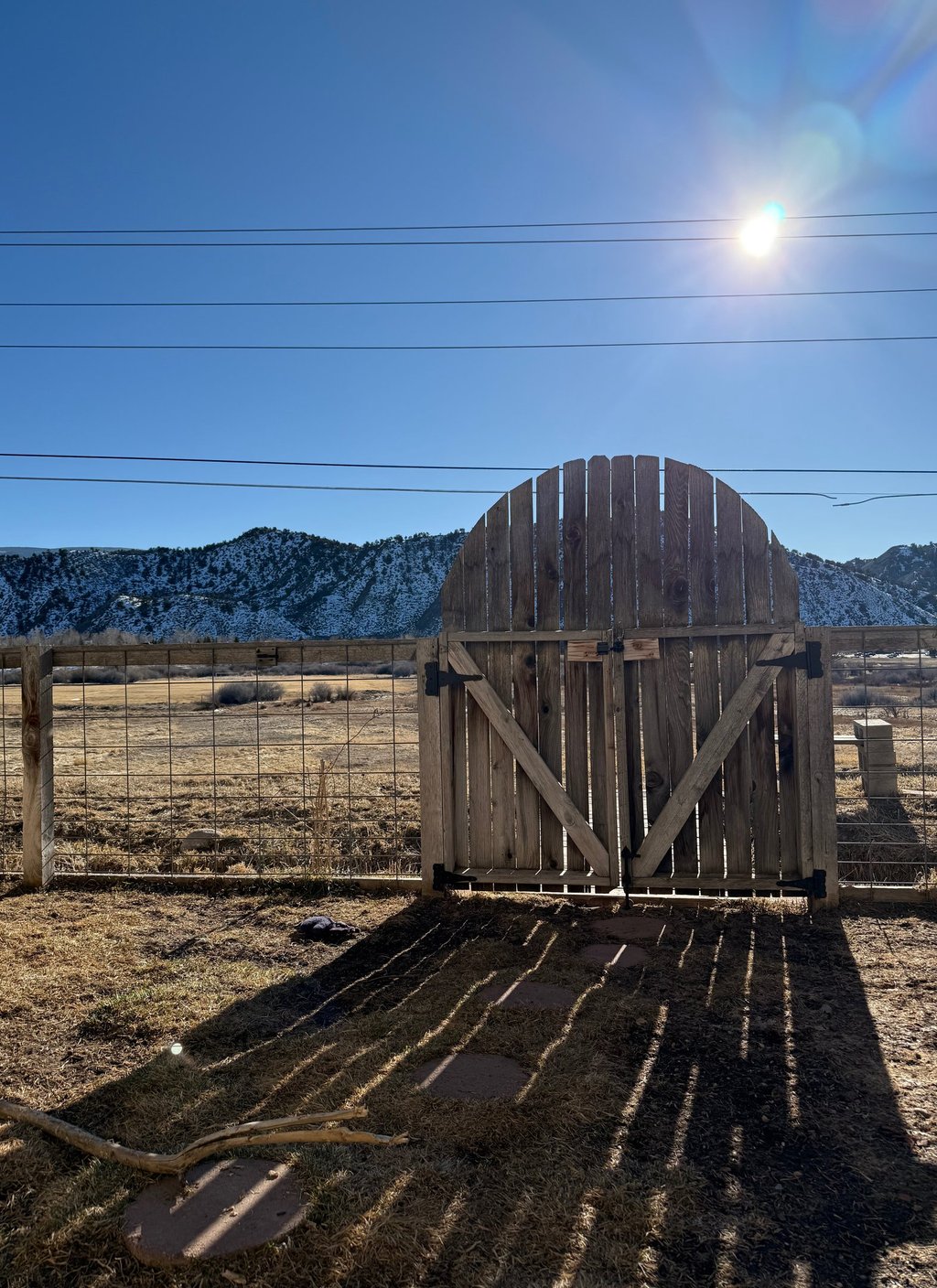 a barn door with a wooden gate and a fenced in area