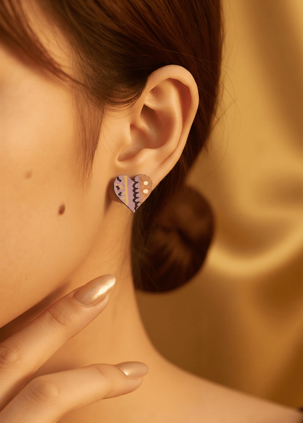 Close up of woman's ear wearing handpainted earring