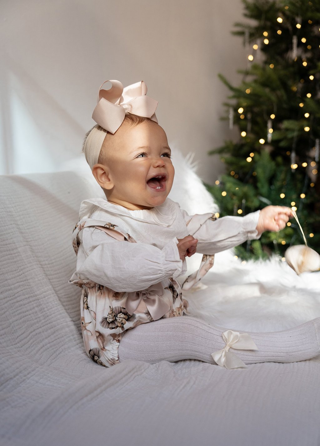 Smiling baby portrait captured during a Christmas family photography session.