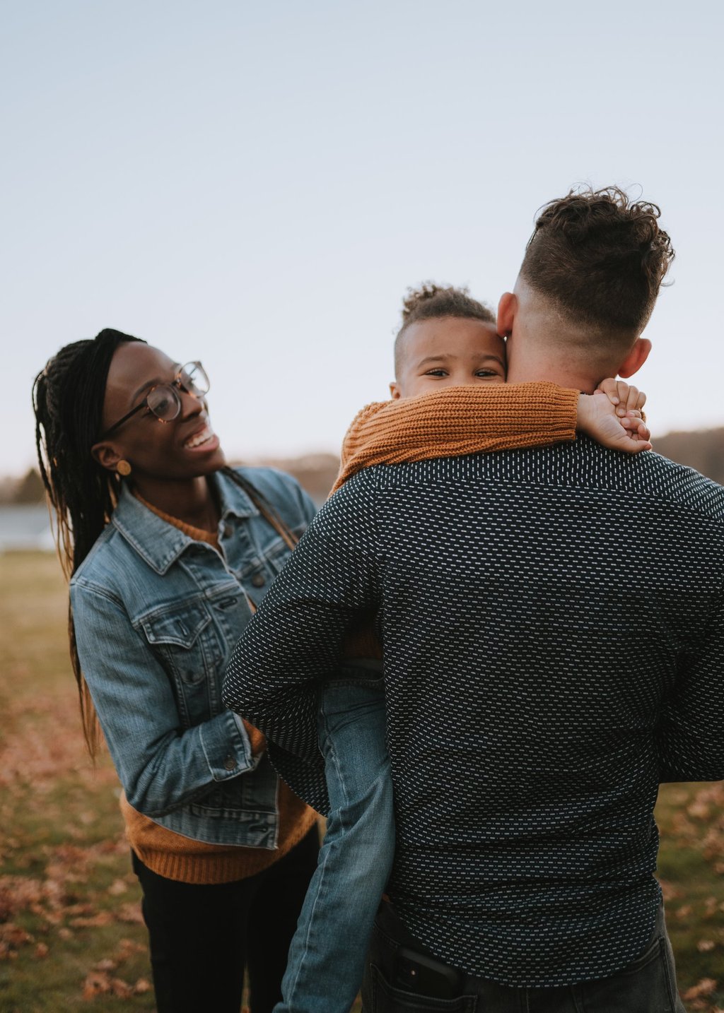Family in field smiling with child