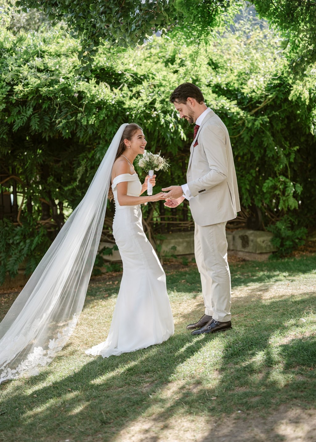 Wedding couple holding hands outdoors at a green Surrey wedding venue