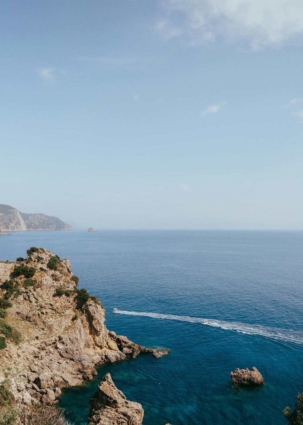 a person standing on a cliff overlooking a body of water