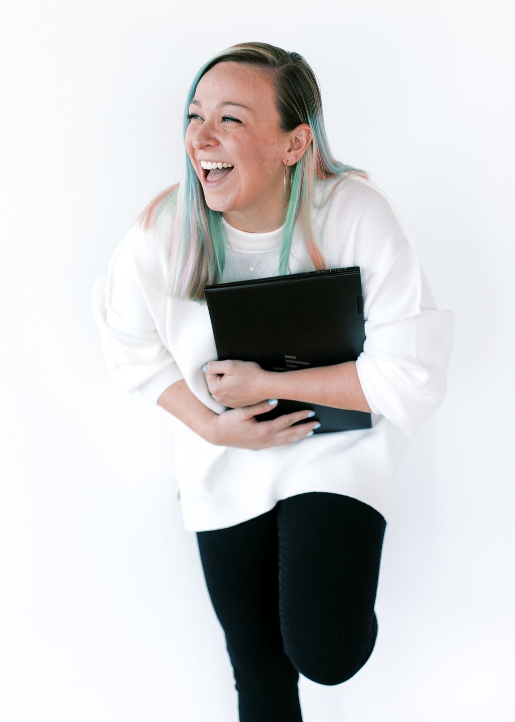 tabitha with butterfly effect consulting laughing with her laptop