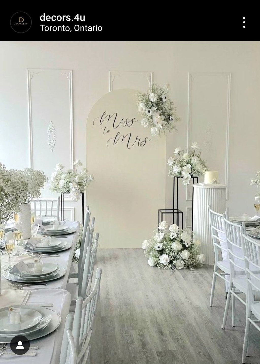 Bridal shower in an off white theme with 5 floral arrangements on black stands
