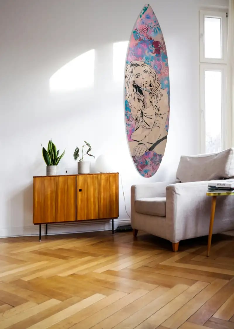 livingroom with Efin surfboard art on wall