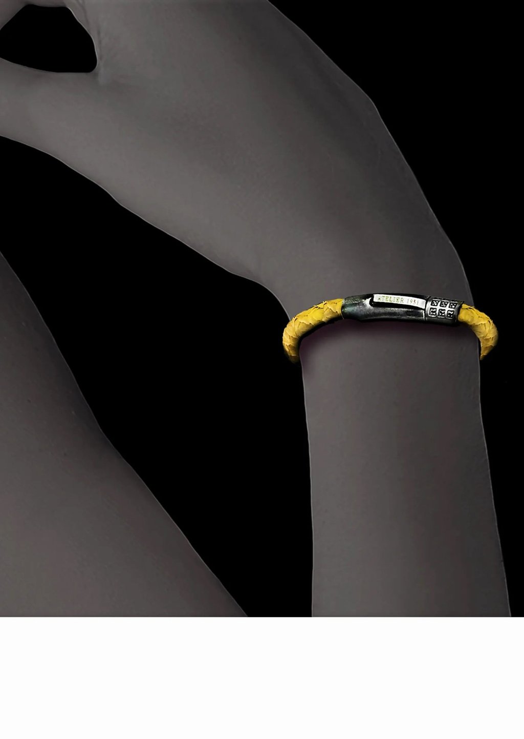 A luxury yellow braided fish leather bracelet with a silver clasp worn on a wrist.