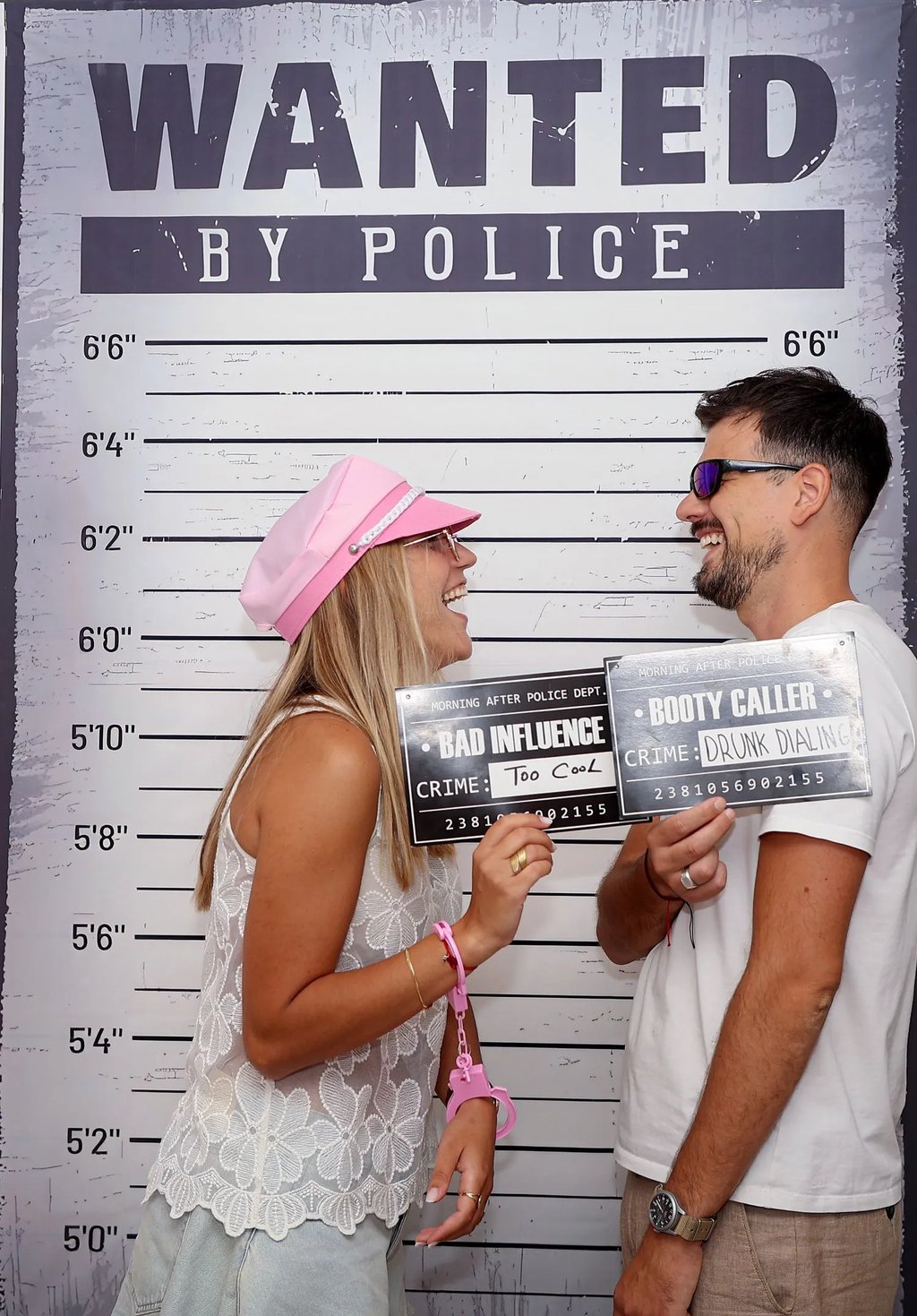 Friends posing with police mugshot boards Selfie Experience Split interactive museum.