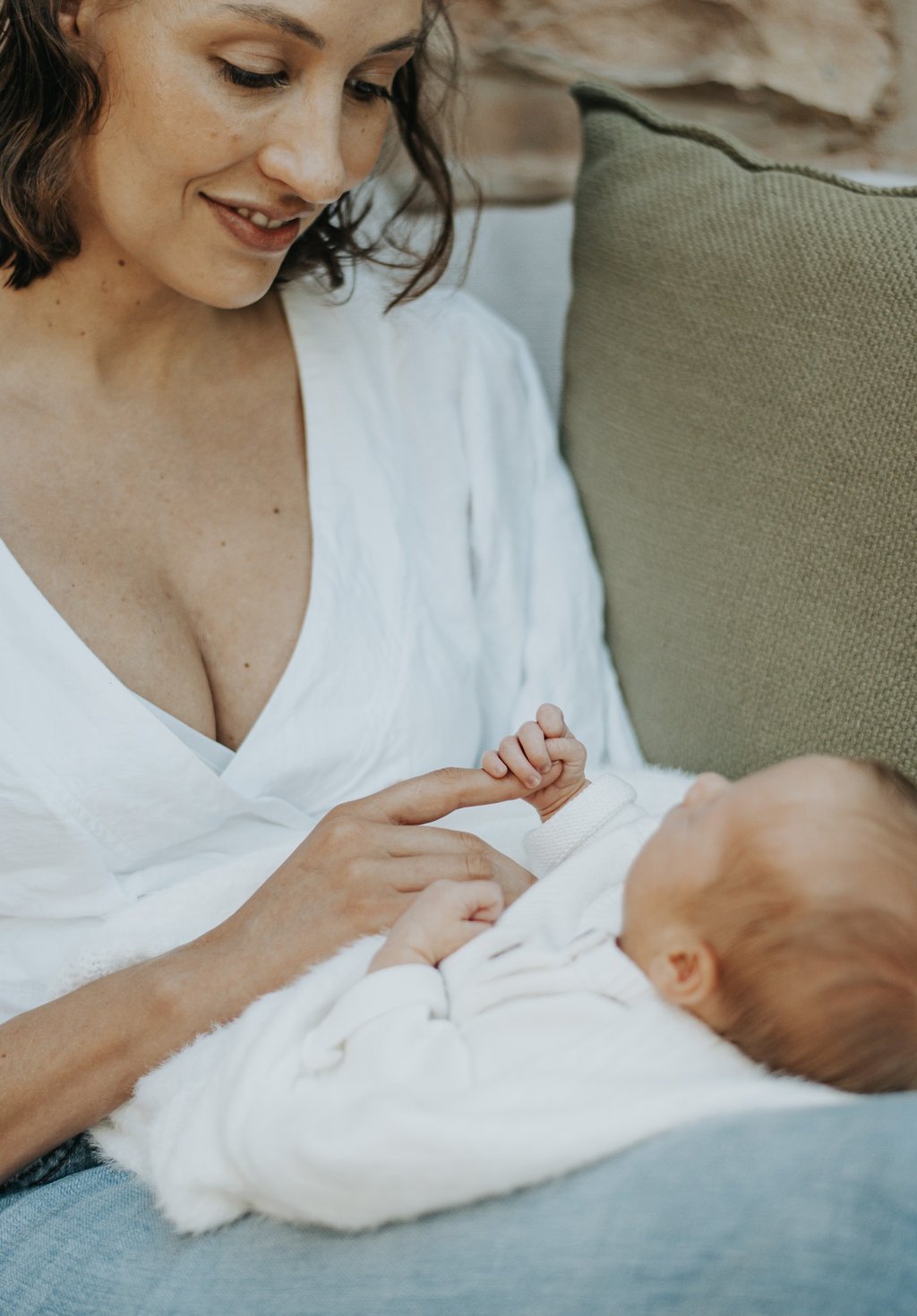 mom looking down at baby in a lifestyle newborn shoot
