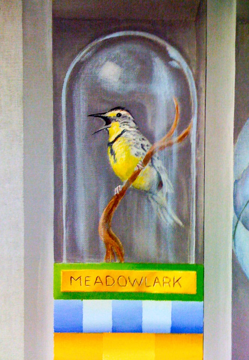 A colourful painting of a bird under a glass globe, placed on stacked books