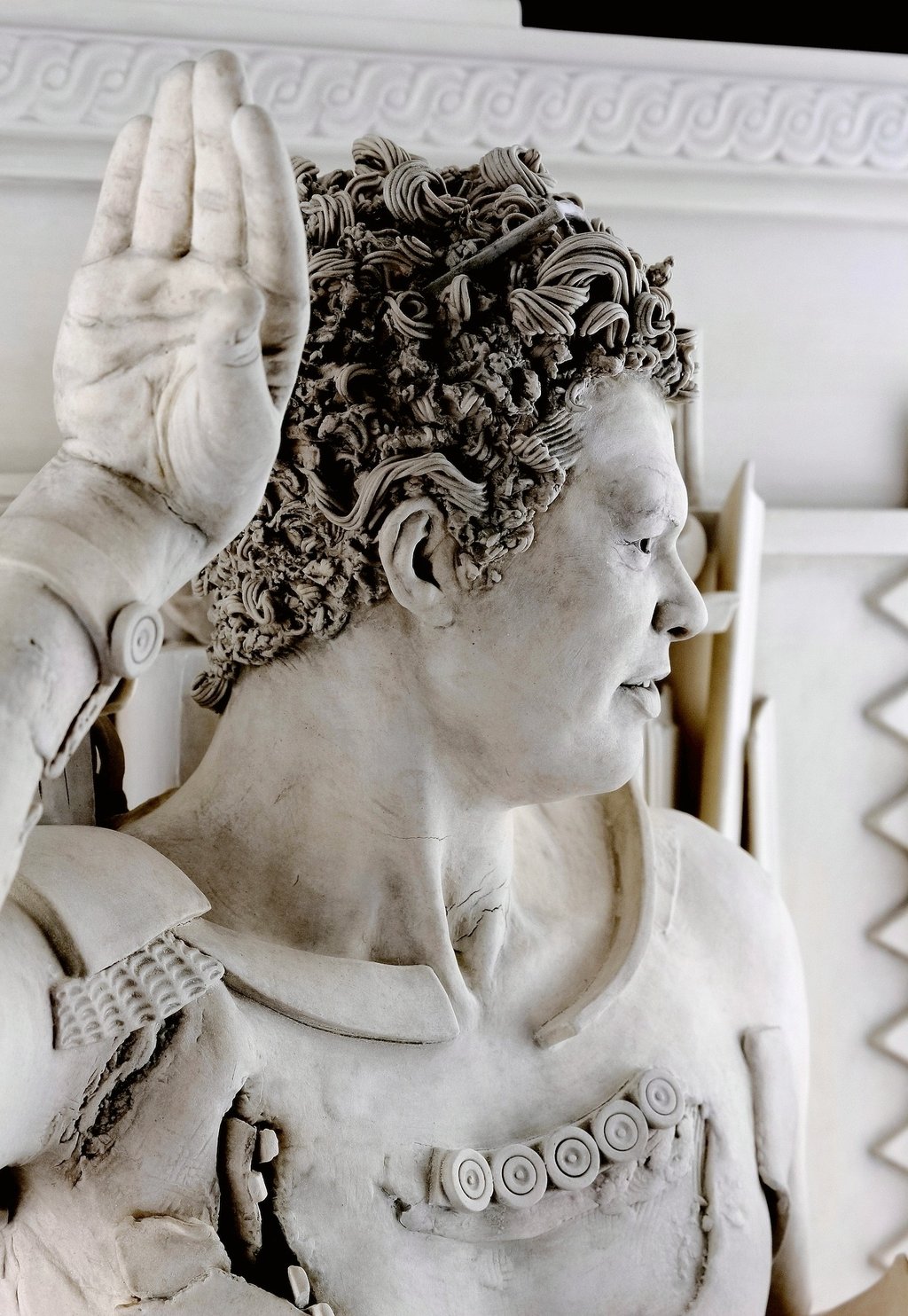 Detail of ceramic sculpture head and hand of fragmented dancing satyr.