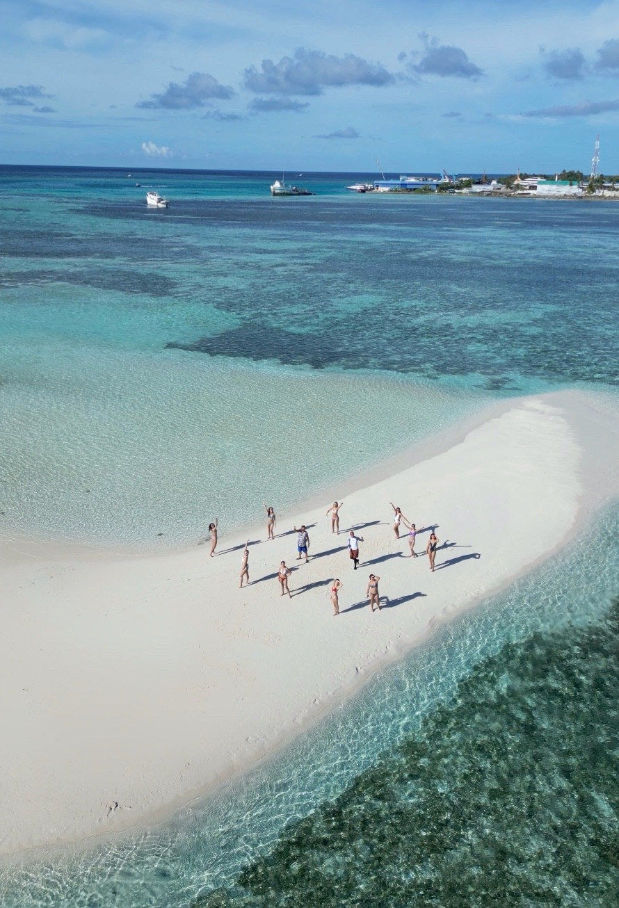 Sandbank in the Maldives. With 12 people enjoying their private group time middle of the ocean.