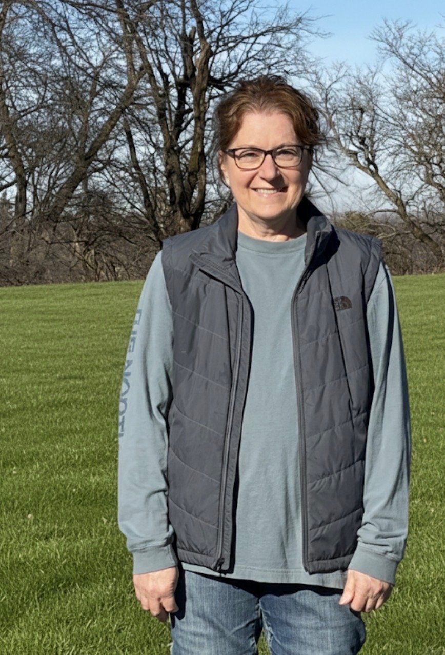 Farm owner standing alone in the field.