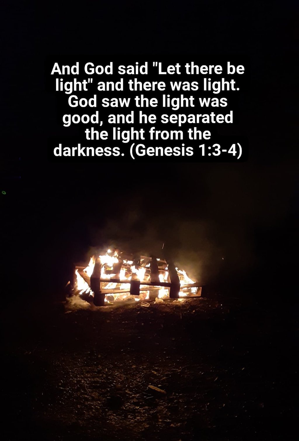 Bonfire with text from Genesis chapter 1