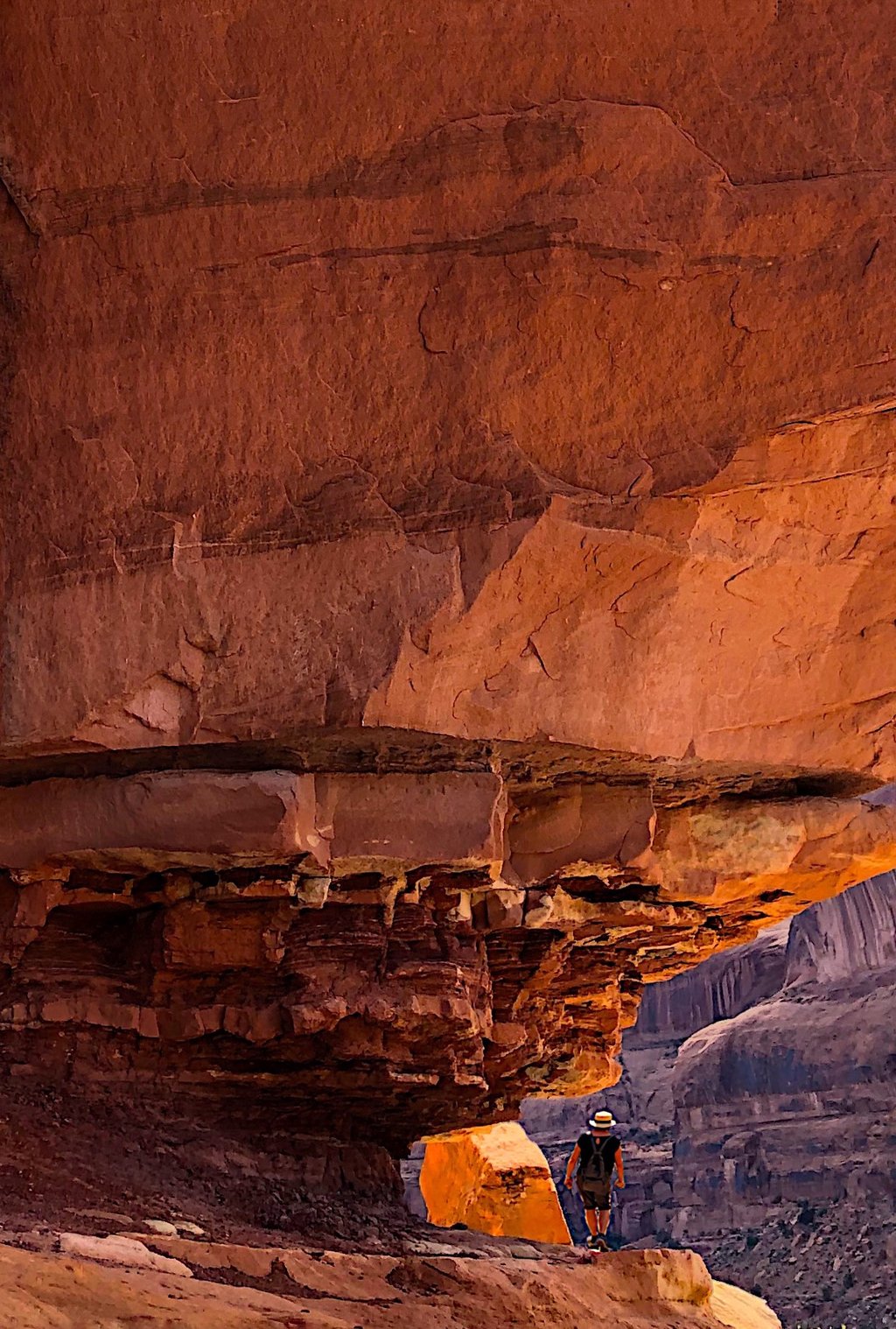 person hiking on a rock formation in the desert near Moab