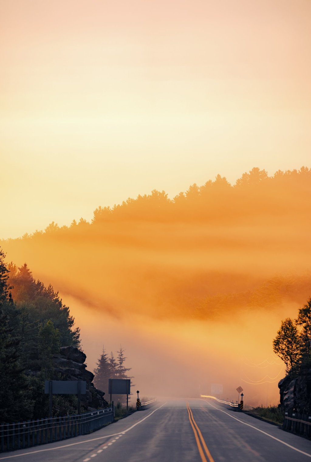 a road sign and a sunrise