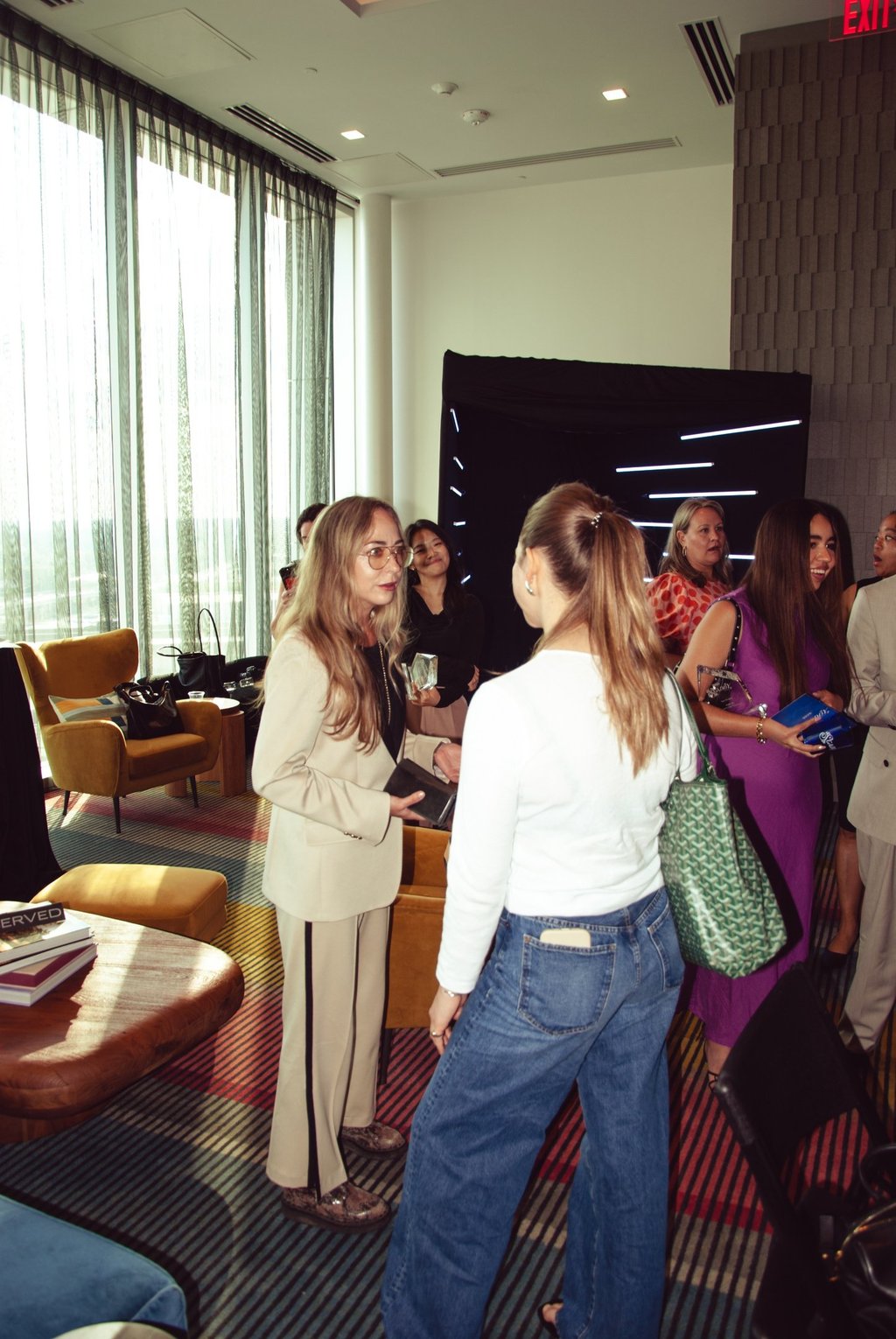 a group of people standing around a table