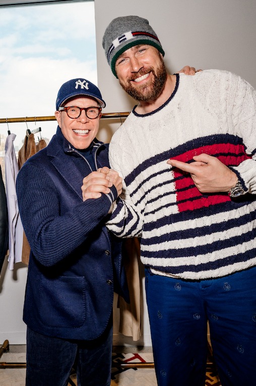 Tommy Hilfiger and Travis Kelce posing together at a fashion event wearing Tommy Hilfiger clothing.