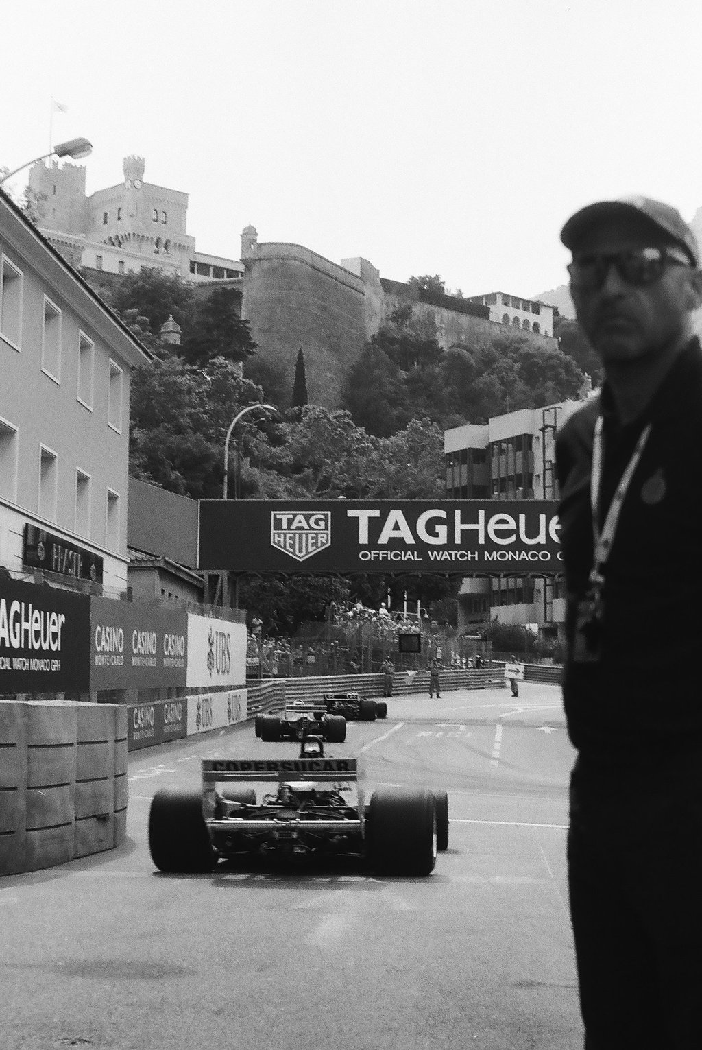 a race marshal watching the race cars get onto the circuit