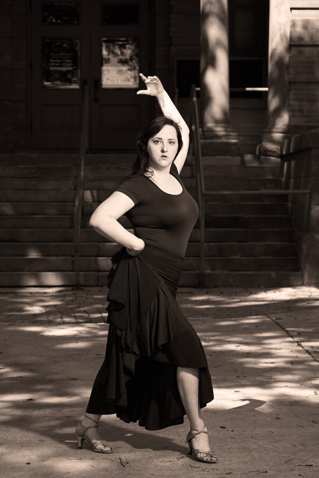a woman in a dress dancing in a latin dance style