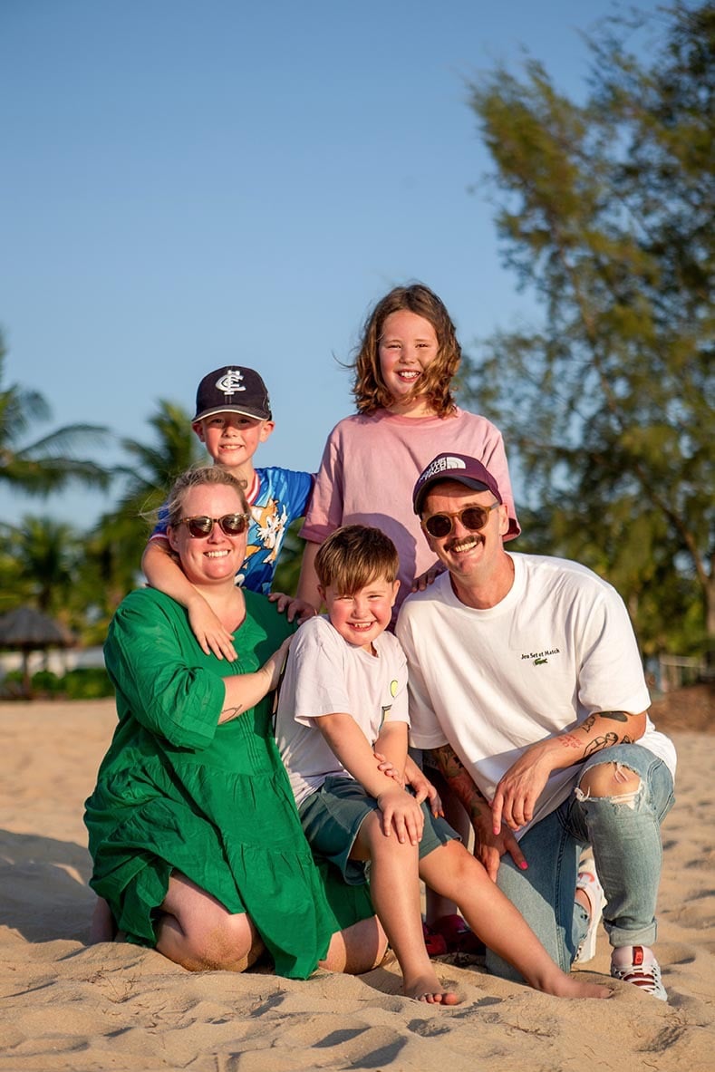 Family portrait on the sand during a family photoshoot at Mövenpick Resort Phu Quoc