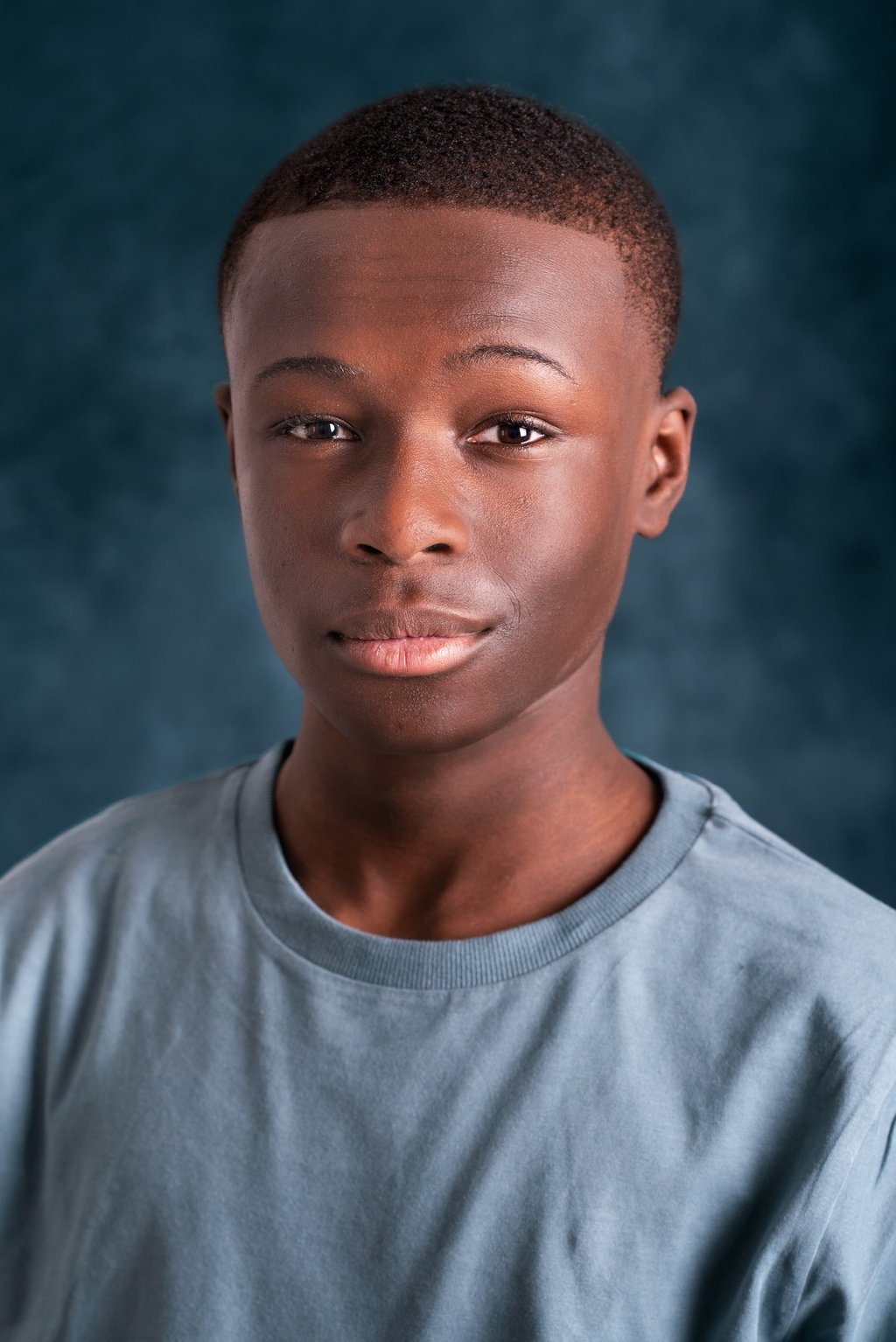 a young man with a blue shirt and a white shirt