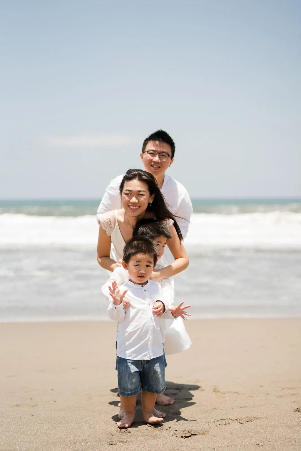 Natural family portrait during a relaxed beach session in Seminyak Bali