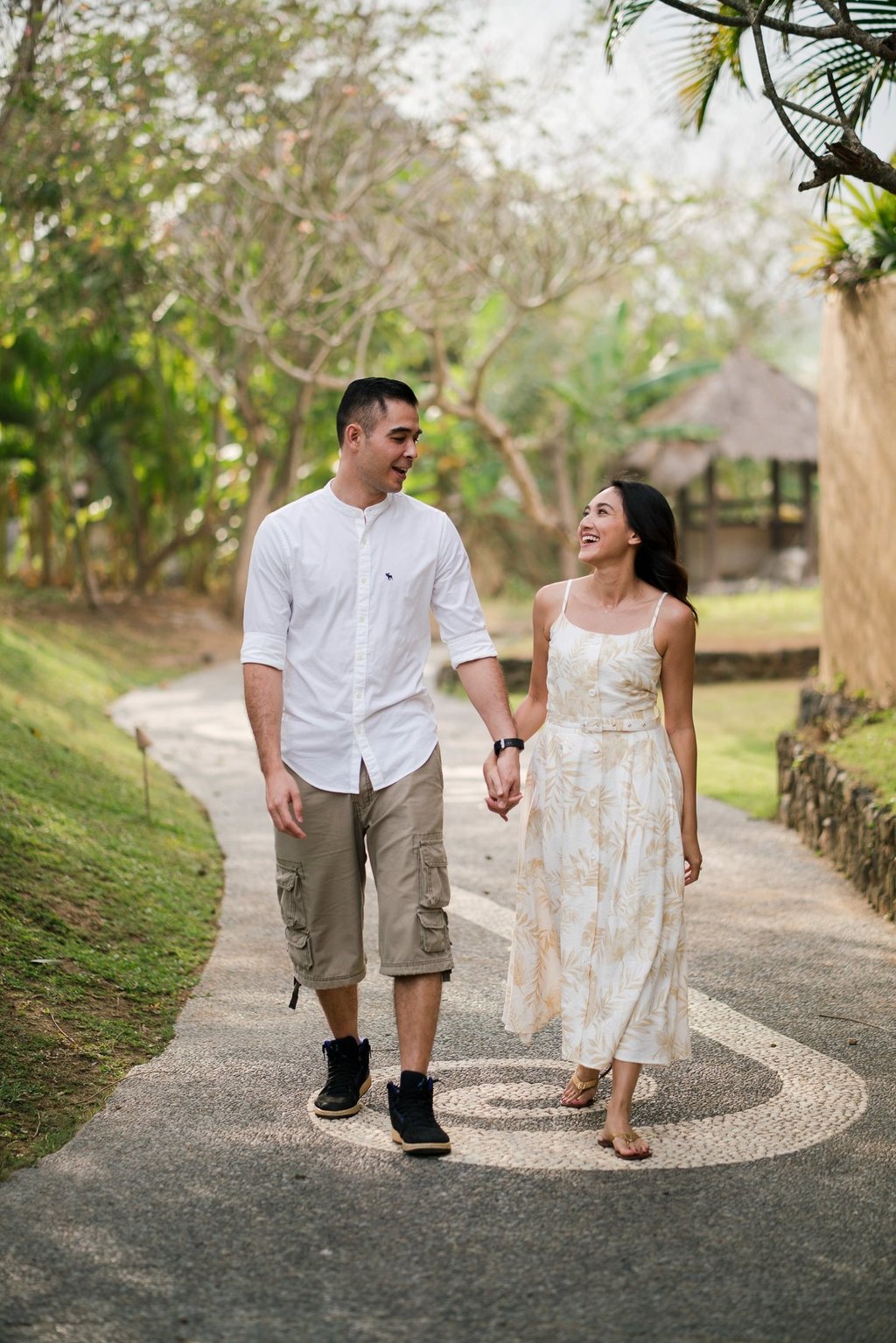 Intimate couple walking inside Waka Gangga resort garden in Tabanan West Bali