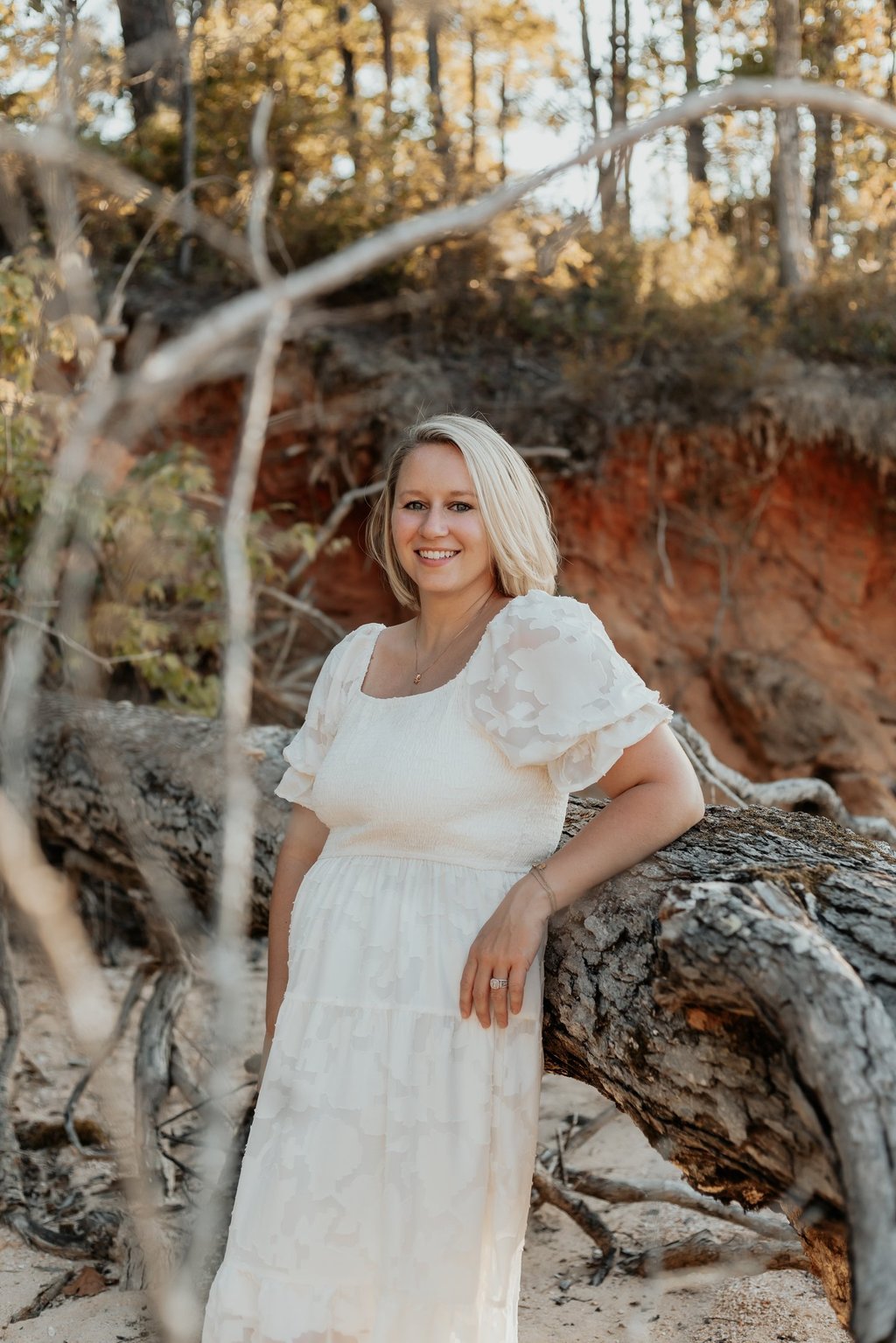 Picture of Emily by a fallen tree